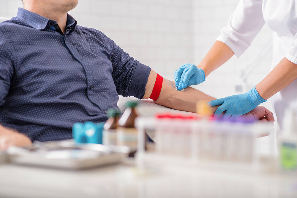 close-nurse-disinfecting-male-arm-preparing-testosterone-blood-test-testing